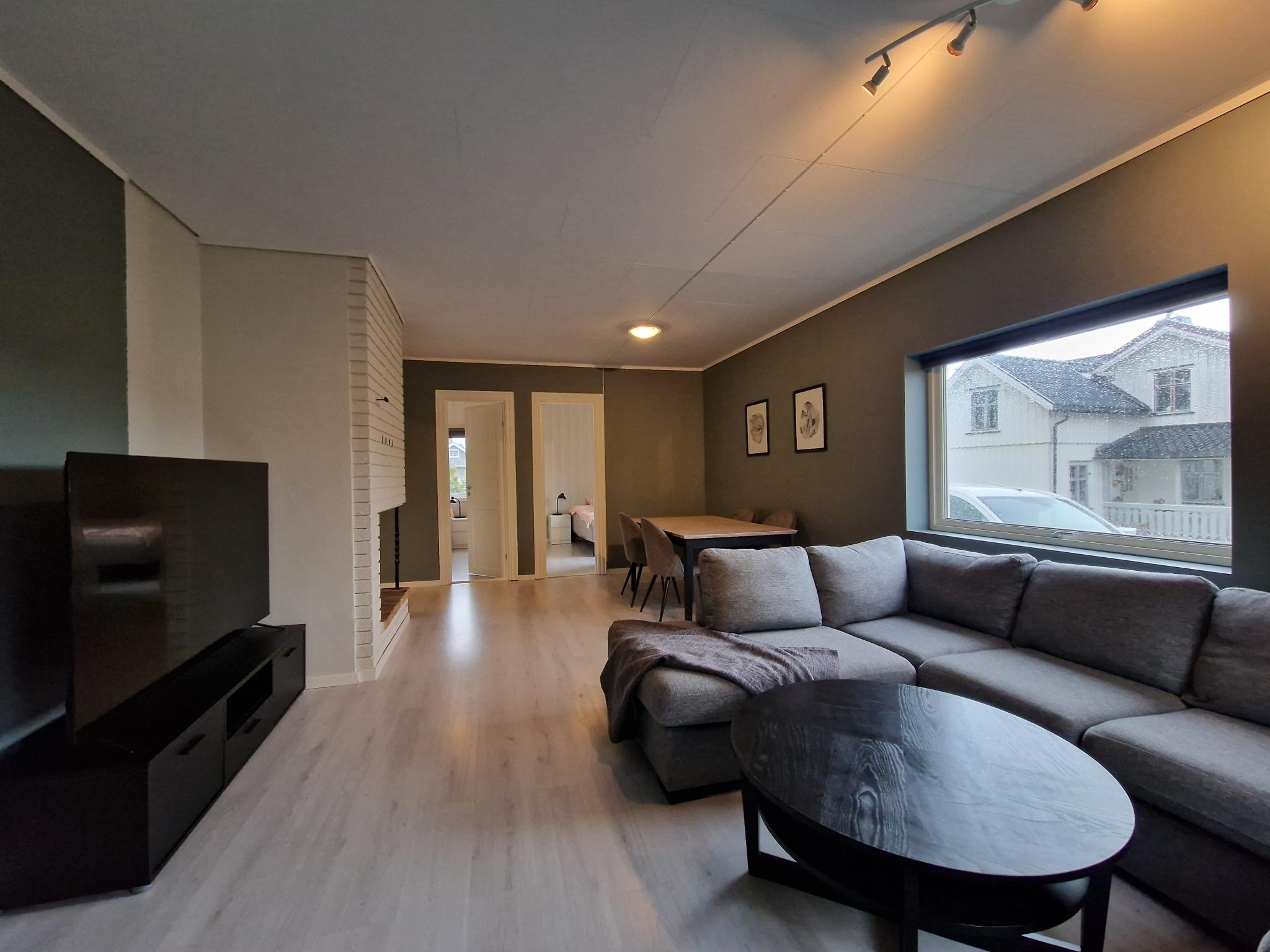 Spacious living room with 65" Smart TV and large sofa